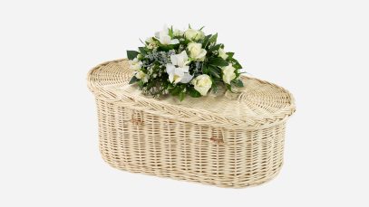 Baby crib casket featuring plaited loop and wooden toggle closures, in the natural white willow colour