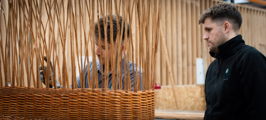 A mastercraftsman training an apprentice weaver