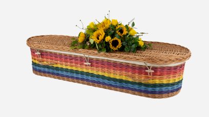 Child's willow coffin with a curved-end shape in rainbow colours, featuring buff woven willow handles