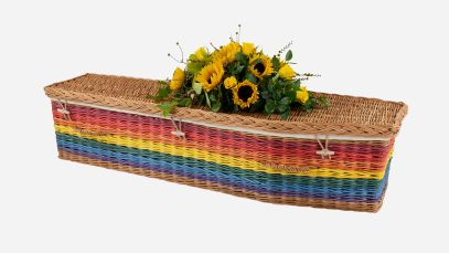 Child's willow coffin with a traditional shape in rainbow colours, featuring buff woven willow handles