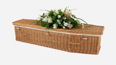 Child's willow coffin with a traditional shape, buff in colour and featuring buff woven willow handles