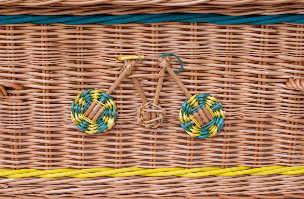Woven willow coffin with a bicycle motif made out of willow.